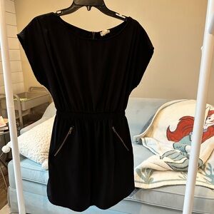 Black, junior size small, unlined dress. Has working zipper pockets